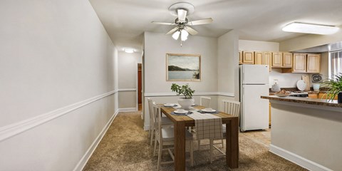 a dining room and kitchen with a table and chairs