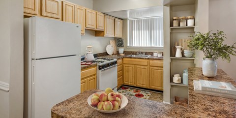 a kitchen with white appliances and wooden cabinets