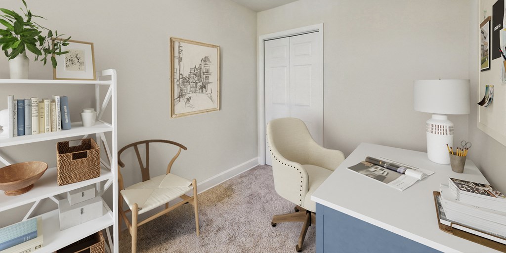 a home office with a desk and chair and a door to a closet