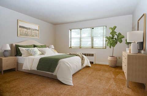 a bedroom with a bed and a potted plant