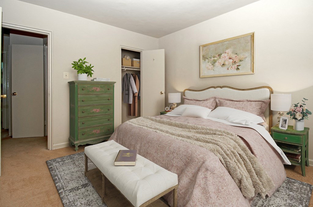 a bedroom with a bed and a dresser and a closet