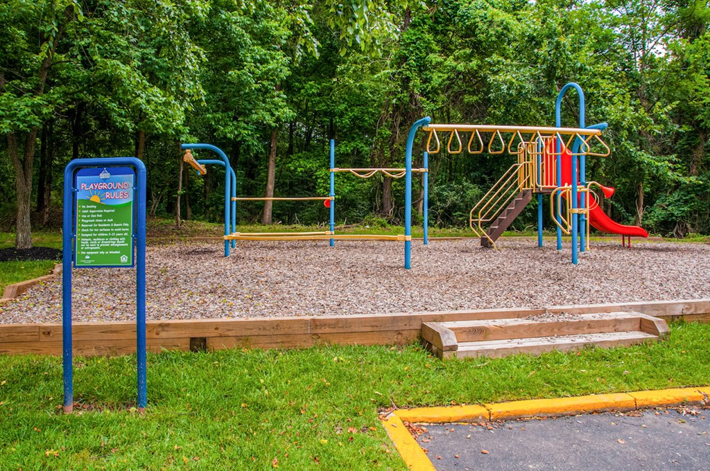 a playground with a sign in front of it