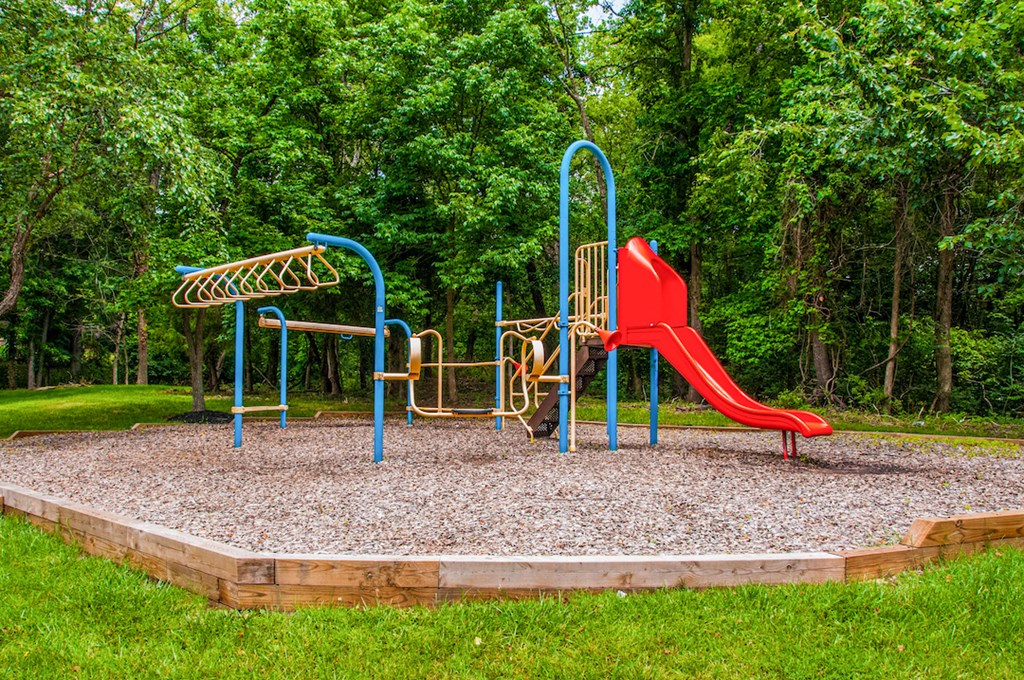 a playground with a slide and a swing set