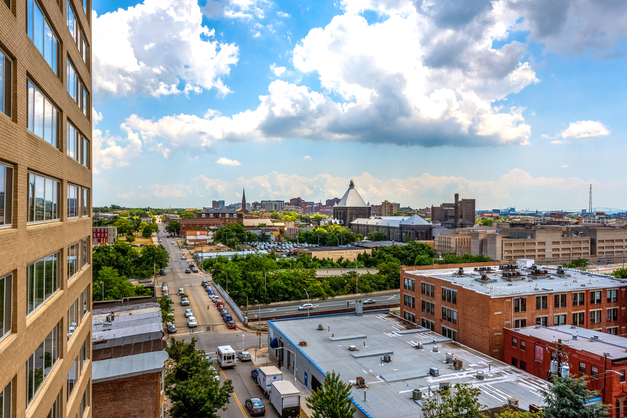 an aerial view of a city with buildings and rooftops and a cloudy sky