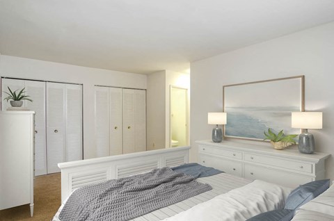 a bedroom with a bed and a painting on the wall