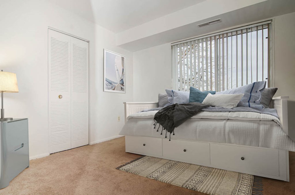 a bedroom with a bed and a window