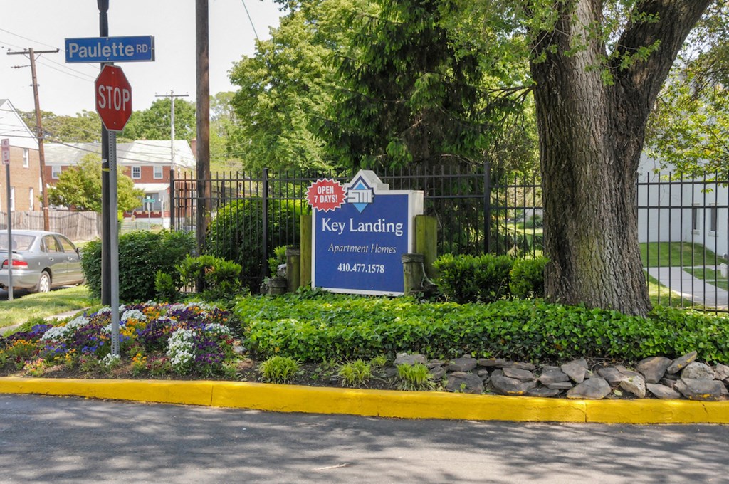 the sign for key landing in front of a tree and a stop sign