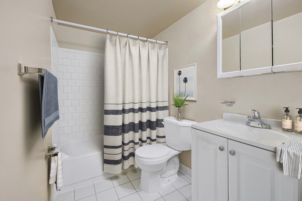 a bathroom with a toilet and a sink and a shower