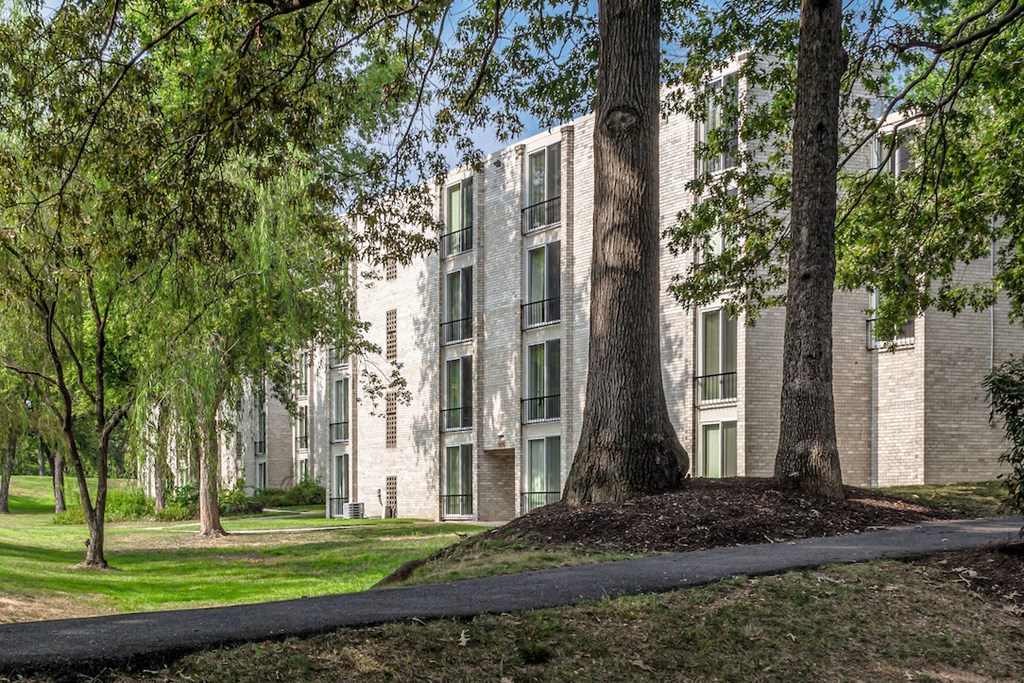 a view of a building with trees in front of it