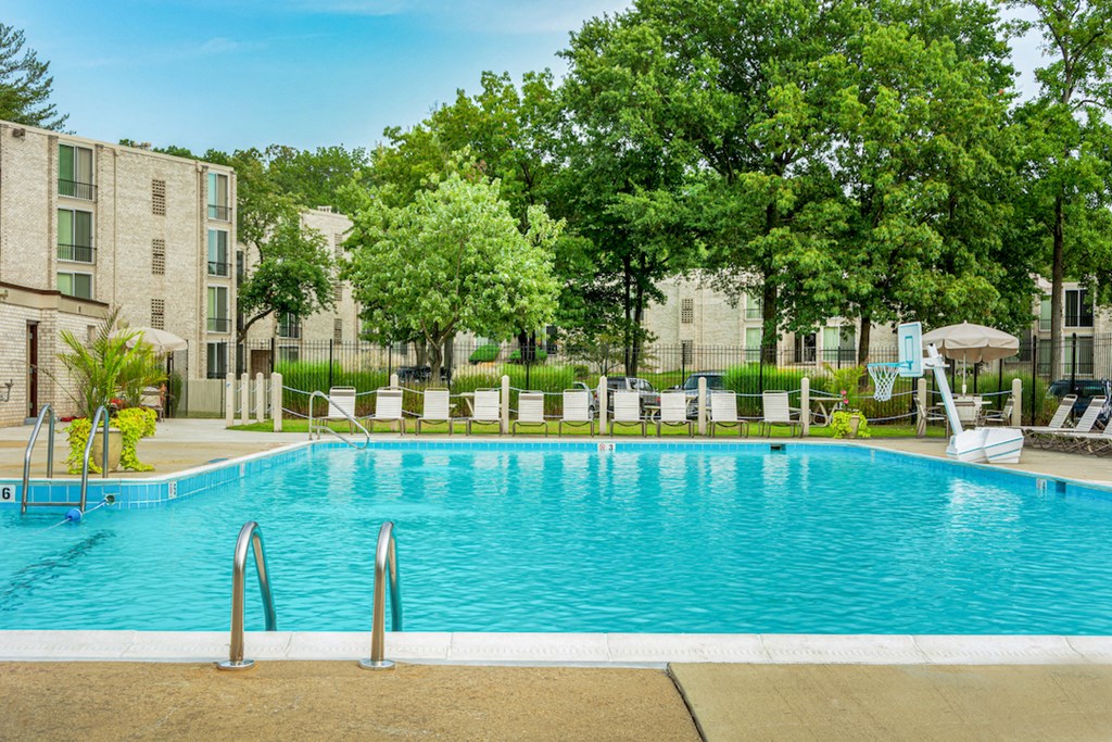 a swimming pool in front of an apartment building