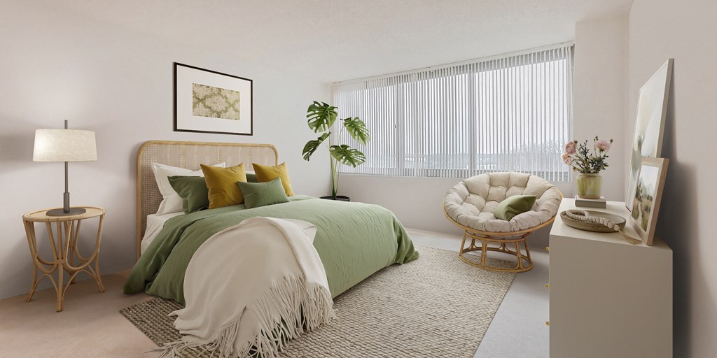 a bedroom with a bed and a chair and a window