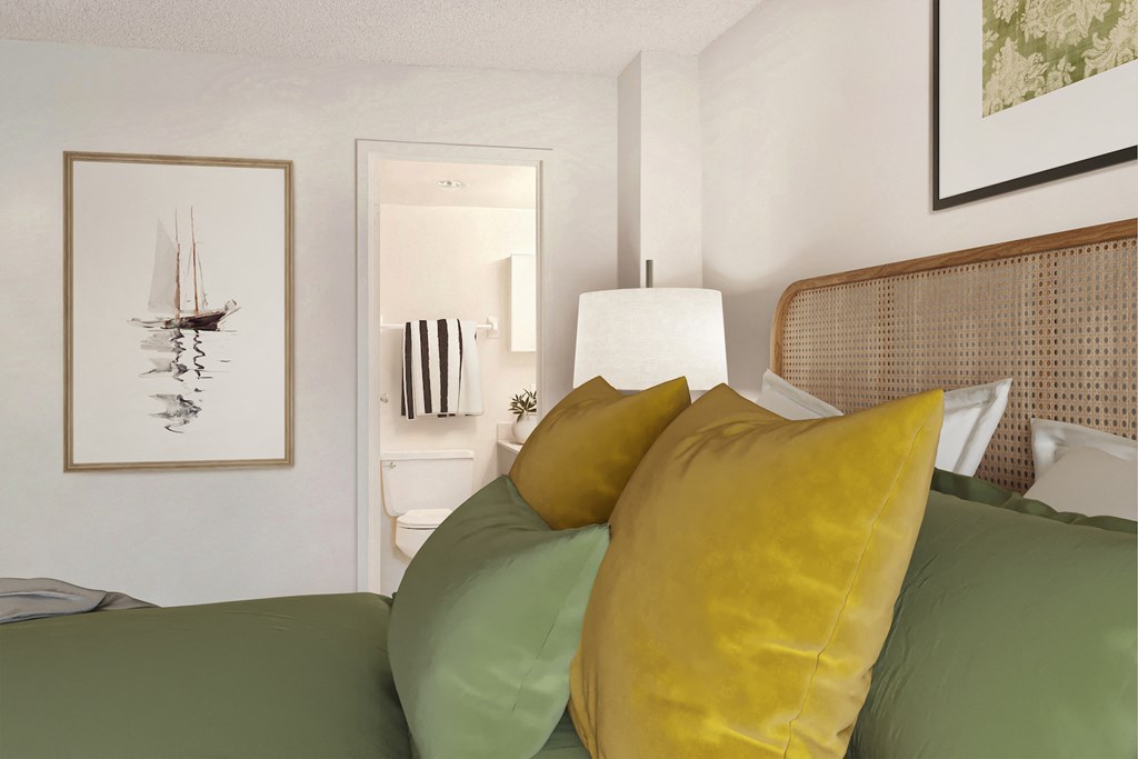 a bedroom with green and yellow pillows on a bed