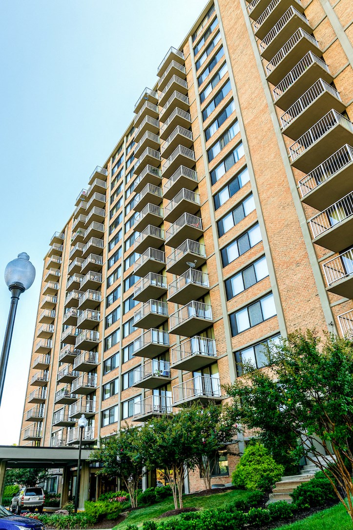 an apartment building with many balconies and a street light in front of it