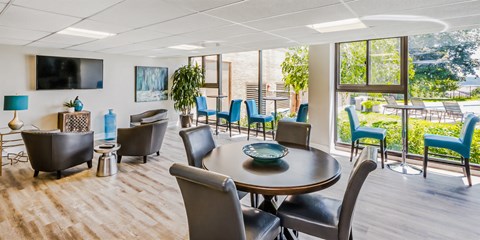 a conference room with a table and chairs and a television