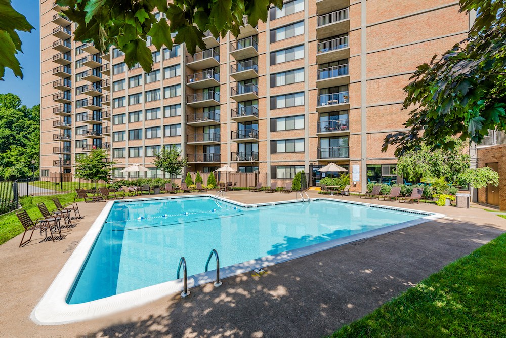 a swimming pool in front of an apartment building