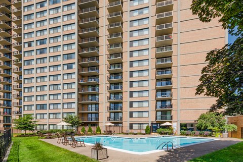 a swimming pool in front of an apartment building