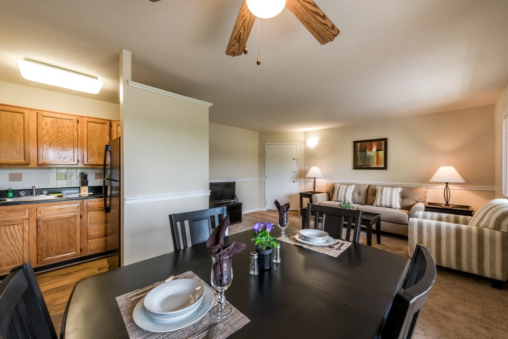 a living room with a dining room table and a kitchen