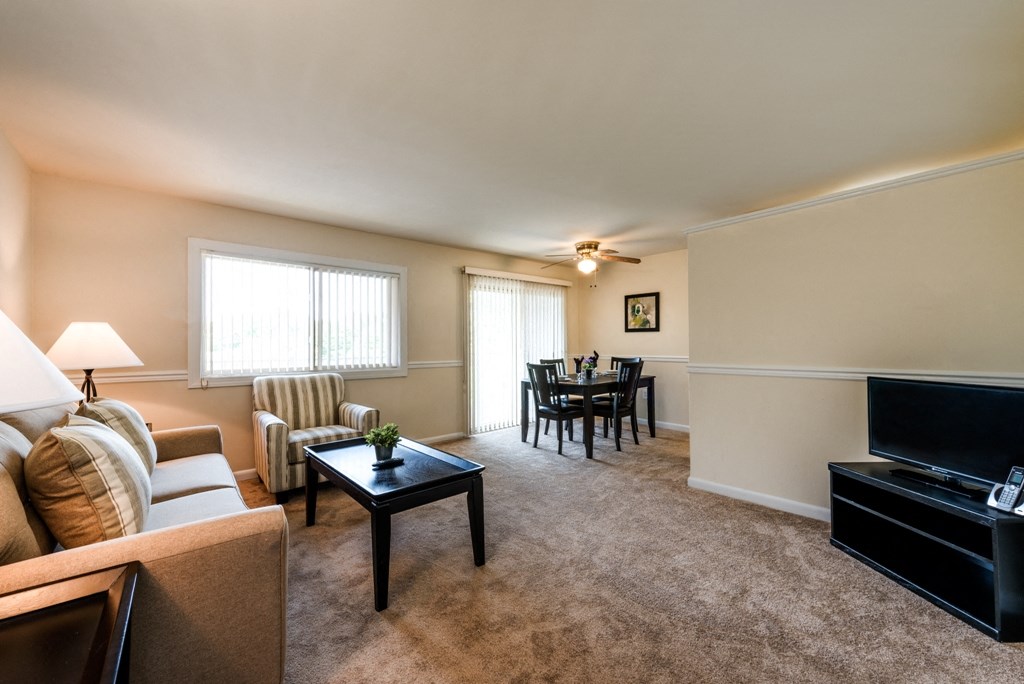 a living room and dining room with a couch and a table