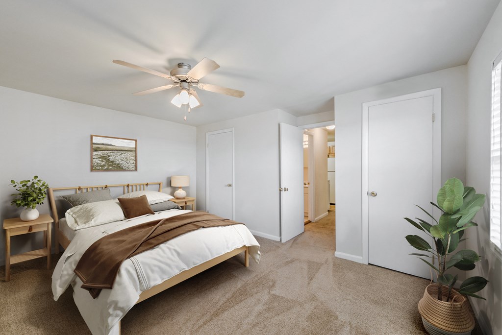 a bedroom with a bed and a ceiling fan