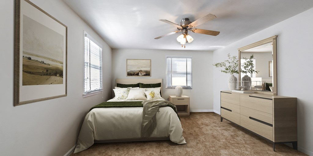 a bedroom with a ceiling fan and a bed