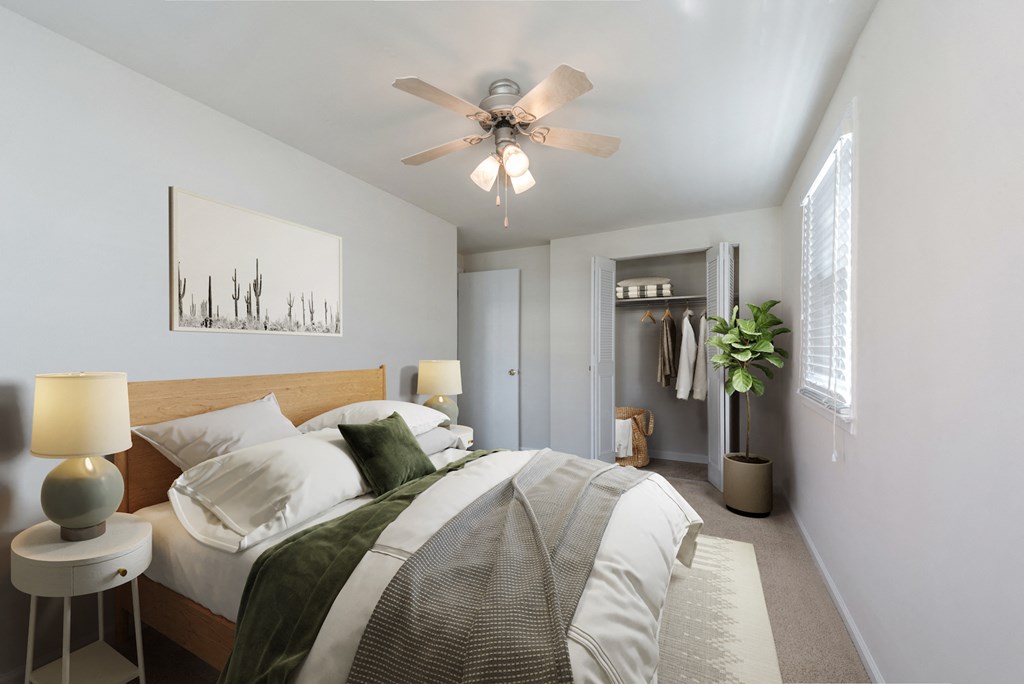 a bedroom with a large bed and a ceiling fan