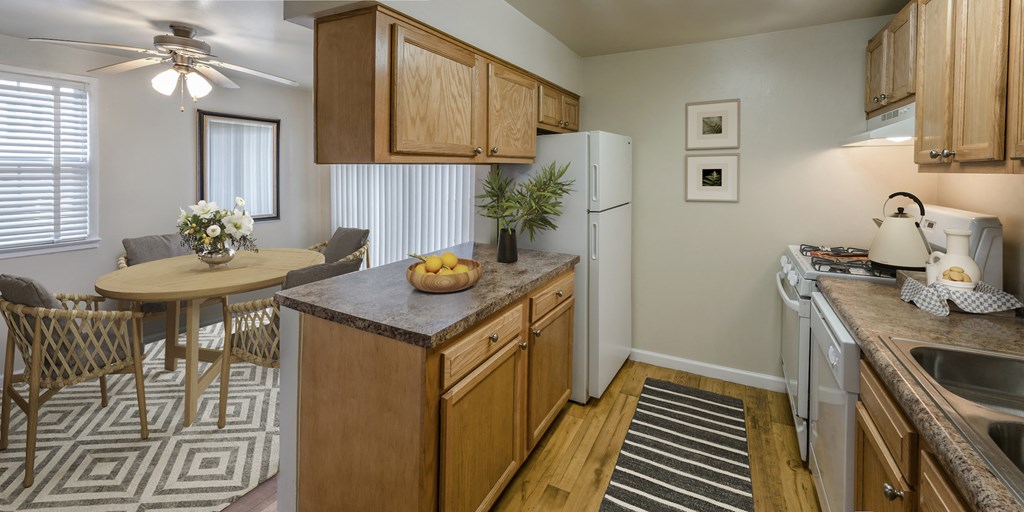 a kitchen and dining area with a table and a refrigerator
