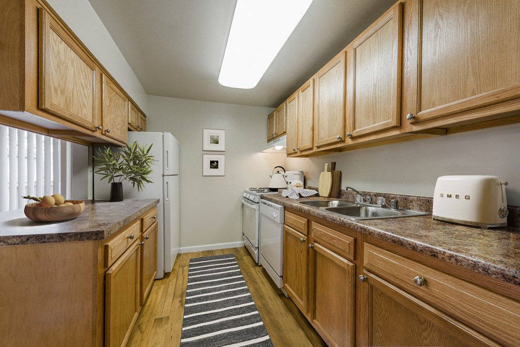 a kitchen with wooden cabinets and a white refrigerator