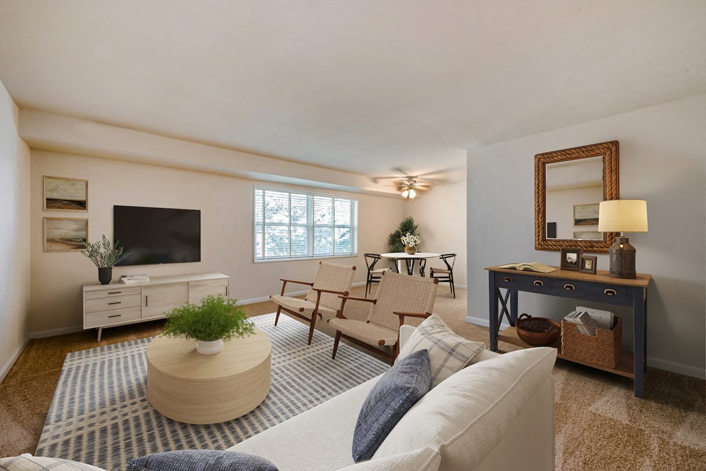 a living room with a couch and chairs and a television