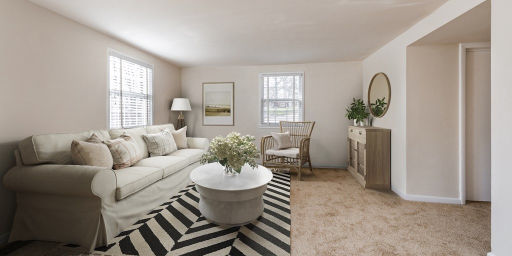 a living room with a white couch and a coffee table