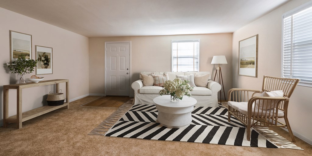 a living room with a white couch and a striped rug