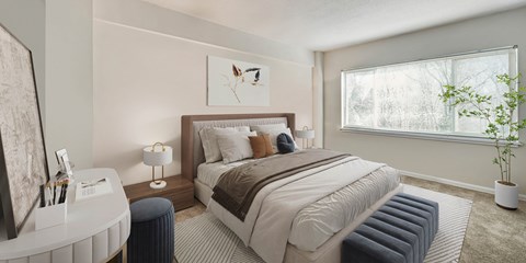 a bedroom with a bed and a desk and a window
