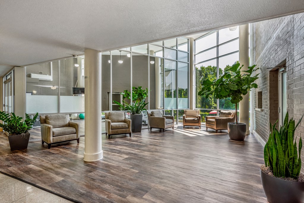 the lobby of a building with seating and large windows