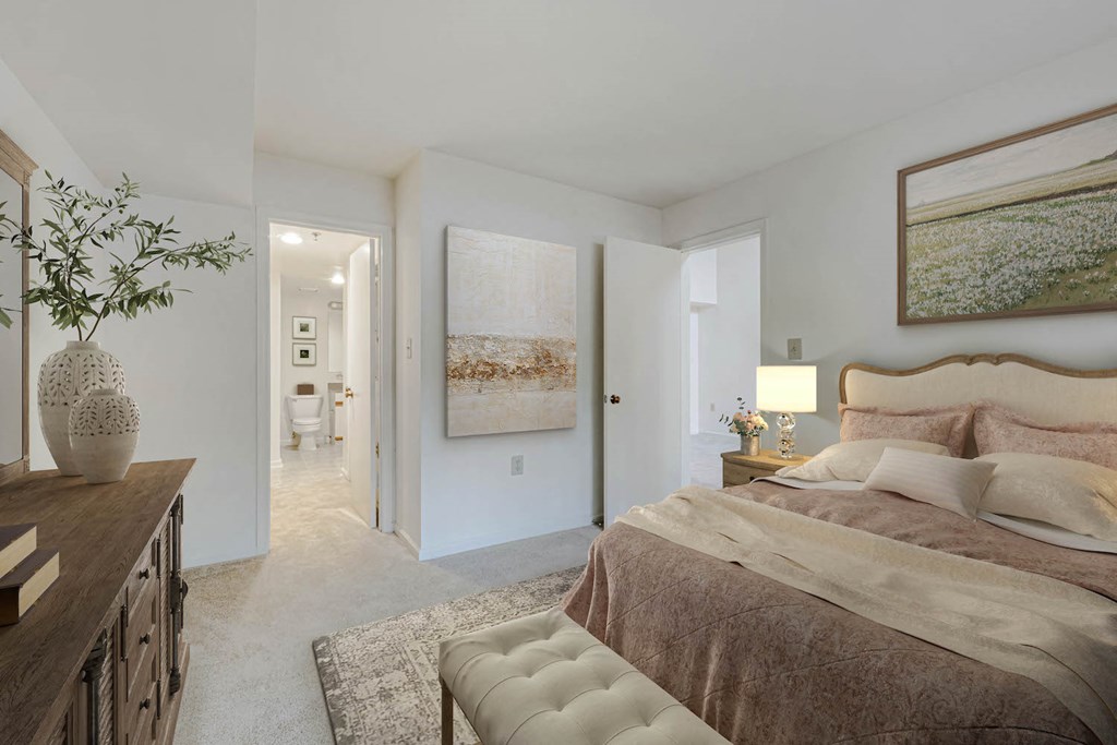 a bedroom with a bed and a hallway to a bathroom