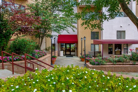 a building with a red awning and flowers outside of it
