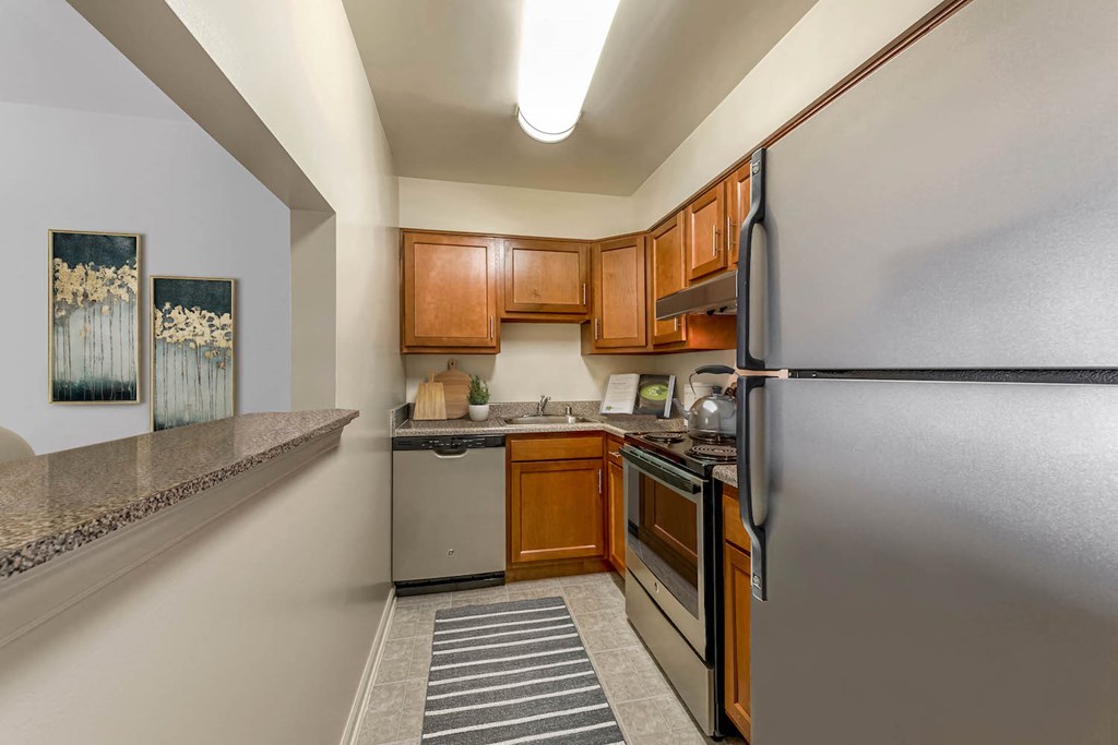 a kitchen with stainless steel appliances and wooden cabinets