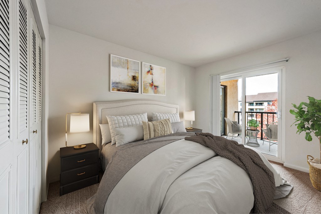 a bedroom with a bed and a door to a balcony