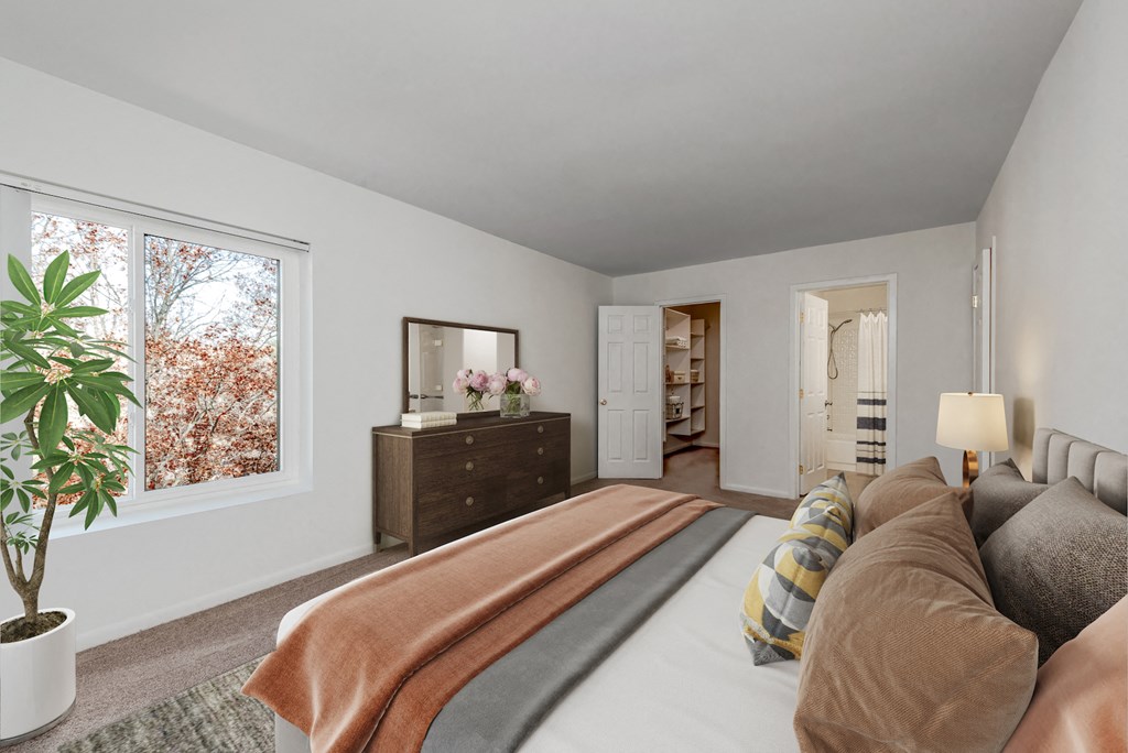 a bedroom with a large bed and a large window