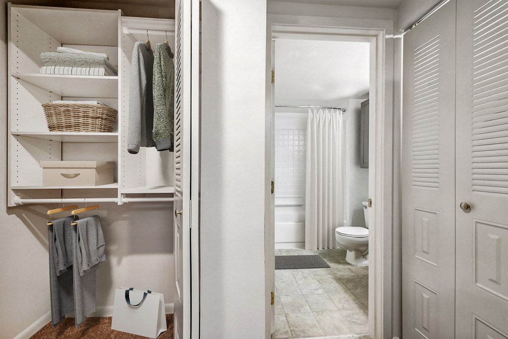 a small bathroom with a closet and a toilet