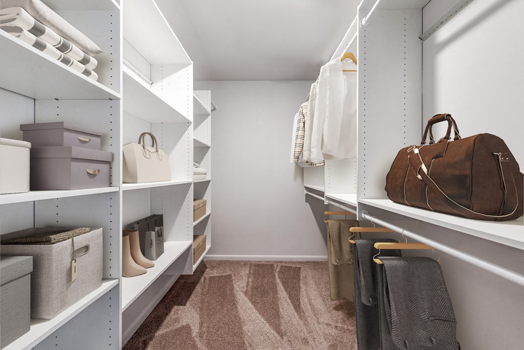 a walk in closet with shelves filled with bags and purses