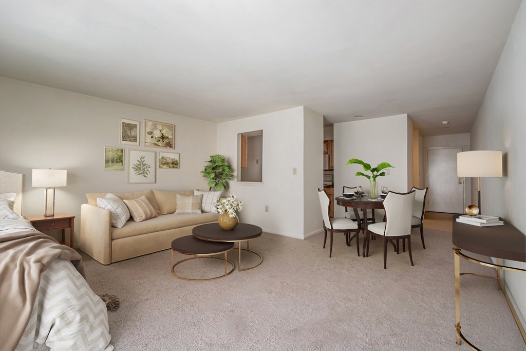 a living room and dining room with a couch and a table
