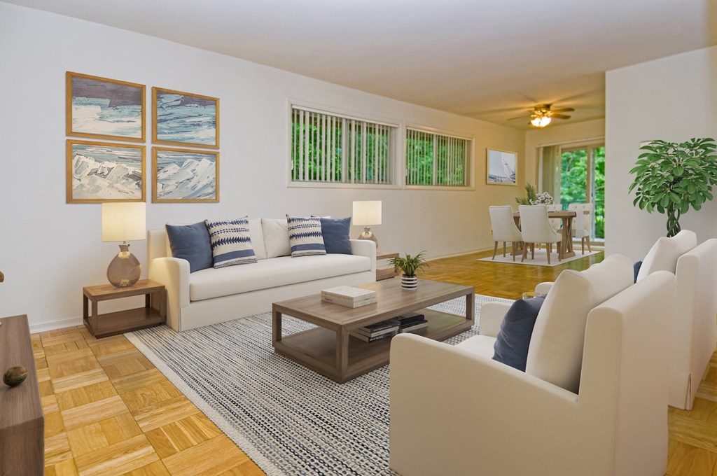 a living room with white couches and chairs and a table