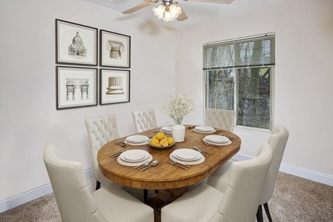 a dining room with a table and chairs and a window