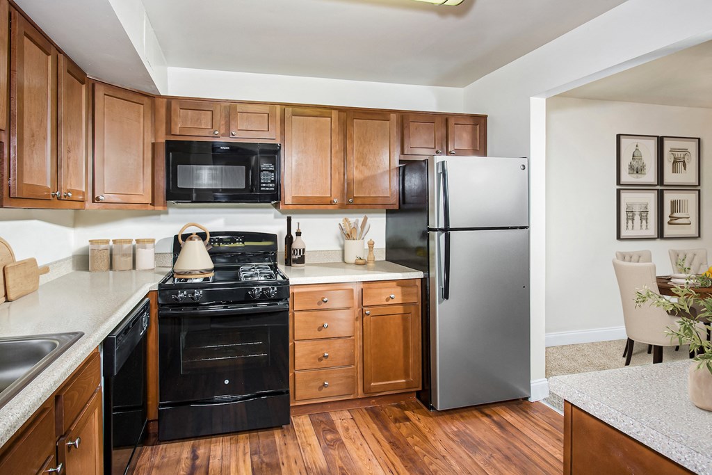 a kitchen with black appliances and wooden cabinets