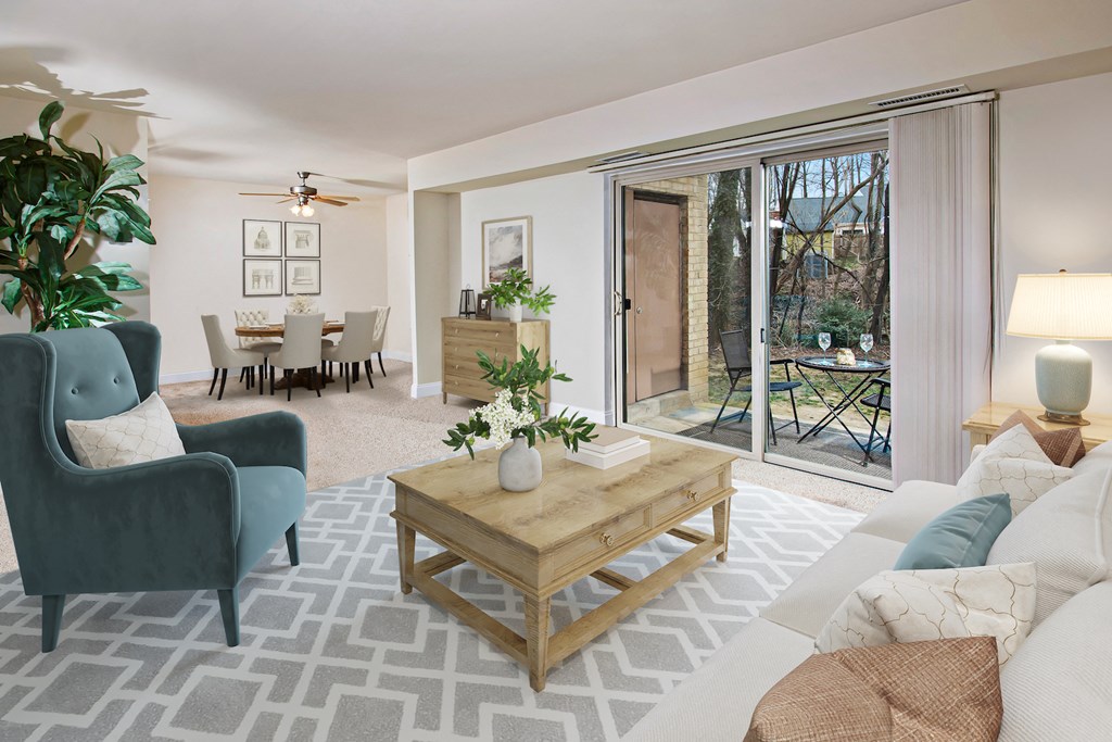a living room with a couch and a coffee table    and a patio