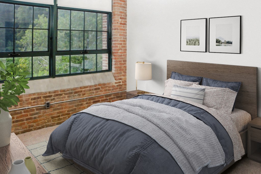 a bedroom with a bed and a brick wall