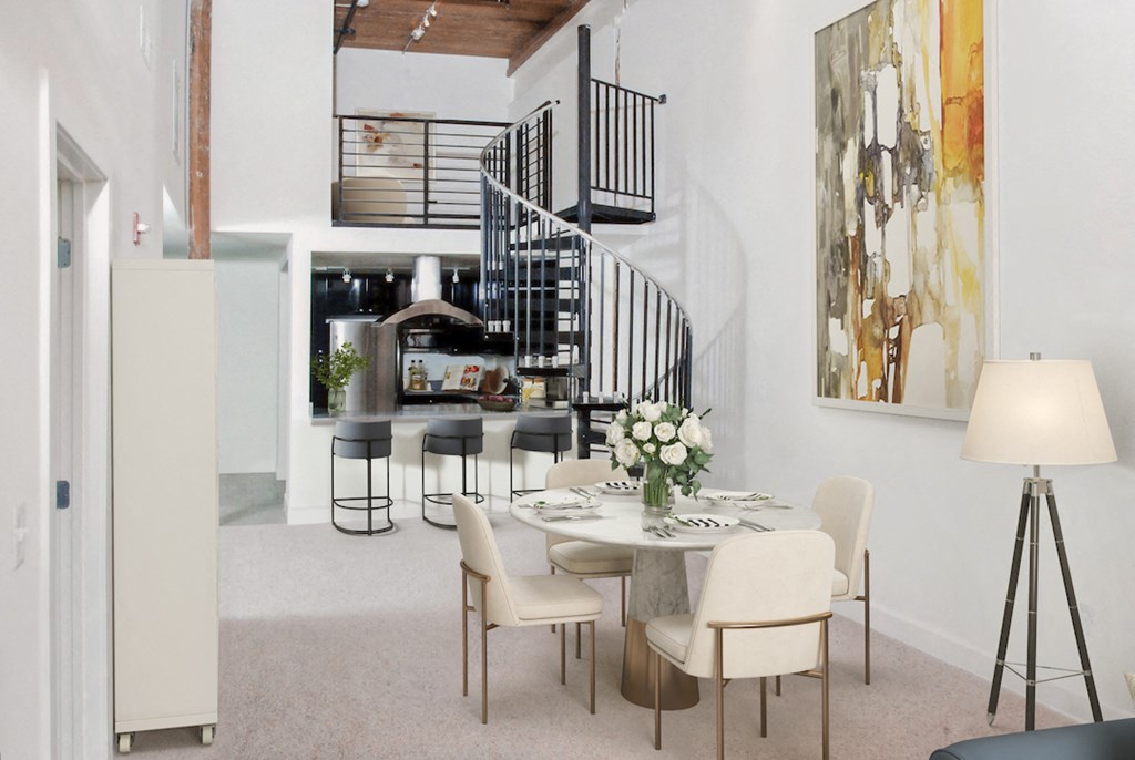 a dining room with a table and chairs and a spiral staircase