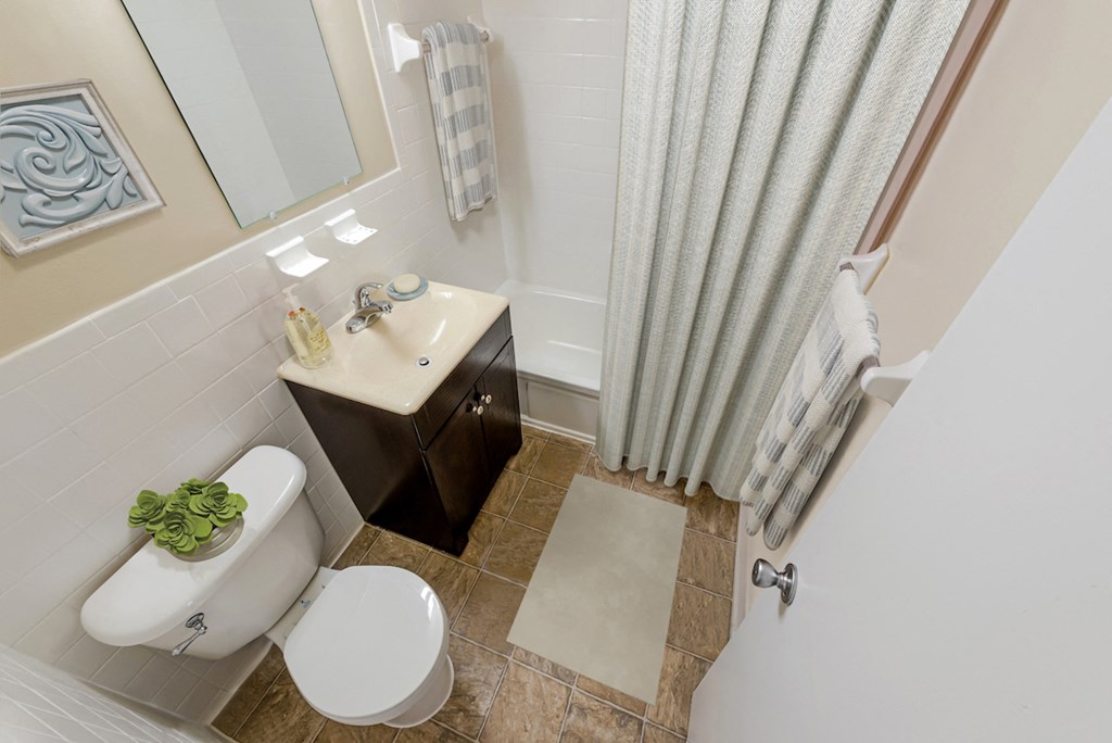 a bathroom with a toilet and a sink and a shower