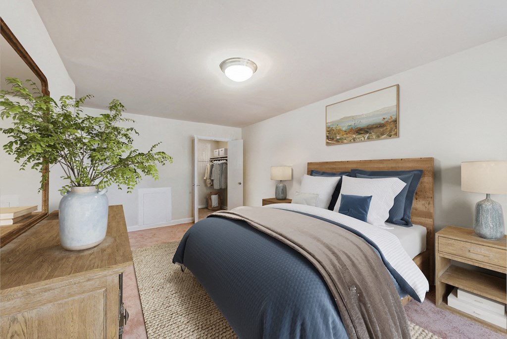 a bedroom with a bed with blue and white bedding and a wooden dresser