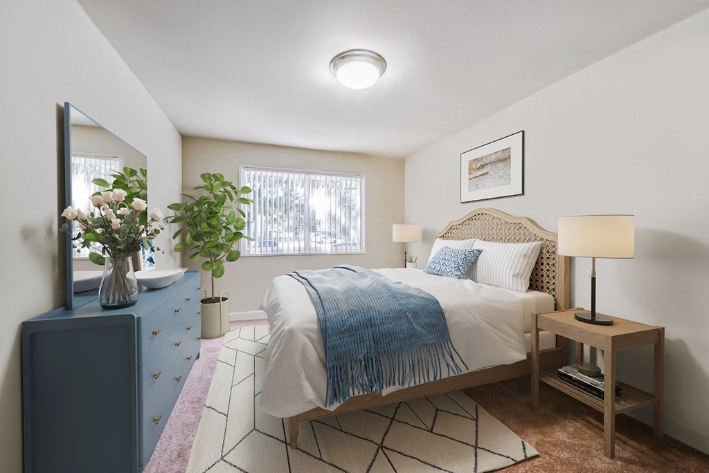 a bedroom with a bed and a dresser and a window