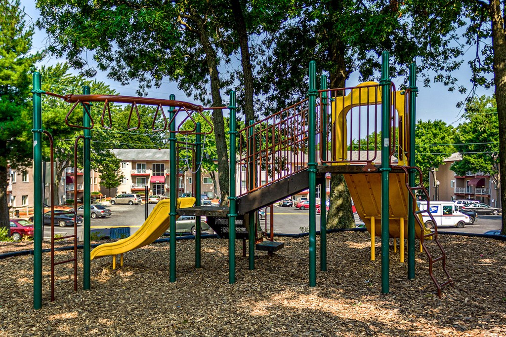a playground with a slide and other toys in a park